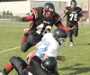 Houston defensive lineman Chris Minsch wraps up the Valdez
ballcarrier as Hawk lineman Andrew Kappler leaps for the tackle
during the first half of Houston's 47-6 romp over the visiting
Bucca