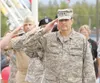 ROBERT DeBERRY/Frontiersman Gen. Craig Campbell salutes during
the singing of the National Anthem Friday at the Governor’s Picnic
in Wasilla.