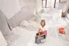 ROBERT DeBERRY/Frontiersman Wasilla resident Jill Rodamer sits
inside a partialy painted plastic-covered room in her house off
Fairview Loop.