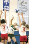 ROBERT DeBERRY/Frontiersman Colony senior outside hitter Kristen
Coan spikes the ball past two Anchorage Christian Lion blockers
during the Palmer Jamboree on Friday. The round-robin event
fe