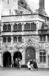 The Basilica of the Holy Blood in Bruges houses a relic of the
blood of Christ. The blood is only displayed to the public during
the Friday services. At right, a local woman makes a piece of 