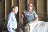 Rep. Carl Gatto, R-Palmer, left, talks with Havemeister Dairy farmhand Floyd Harmon in June 2007 following a rally at the Palmer farm in support of the state’s dairy industry. MATT TUNSETH/Fr