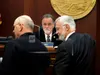 Alaska state Senate President Peter Micciche, center, looks on as lawmakers gather in front of him on the Senate floor on Wednesday, May 4, 2022, in Juneau, Alaska. A bill dealing with the an