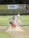Mat-Su Miners second baseman Kevin Lum reaches for the ball as
Athletes in Action Fire’s J.J. Turbin slides into the base last
Friday at Hermon Brothers Field in Palmer. (ROBERT
DeBERRY/Front