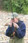 MATT TUNSETH/Frontiersman Anchorage’s Kyla Hagan ties a fly to
the end of her line while fishing in Goose Creek Sunday as part of
a two-day fly fishing class. Presented by the Alaska Departme