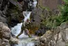 Basic Military Mountaineering Course student 1st Lt. Christopher Peer crosses a stream at the Northern Warfare Training Center’s Black Rapids Site during training. NWTC cadre followed Coronav