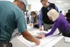 Members of the public examine maps May 21 showing alternate routes for transmission lines through the city. BRIAN O’CONNOR/Frontiersman