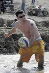Mud volleyball cools of Big Lake Crowd