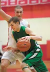 Colony's Hunter Eisenhower drives past Wasilla's Brayden Kuiper during the Warriors win Saturday at Wasilla High School. Robert DeBerry