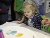 Elliotte Shepard, age 2, surveys her handiwork at Just Add Paint, a pottery store and studio in Wasilla, on Tuesday, Dec. 28. The Shepard family came with their four young children to create 