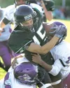 ROBERT DeBERRY/Frontiersman Colony running back Skye Rench is
tackled by Lathrop Malemutes Brandon Olson and Ryan Ivey during
Friday’s game at Colony High School.