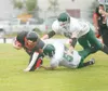 ROBERT DeBERRY/Frontiersman Houston sophmore Brandon Dukes
reaches for additional yardage during the Hawks 47-8 win over the
Delta Huskies Saturday at Houston High School.