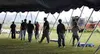 Alaska Job Corps students help place poles that support the roof
of the tent and become the side braces. Photo by AMY
MENEREY/Frontiersman.