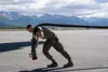 U.S Air Force Senior Airman Weslee Anderson, a 673d Logistics Readiness Squadron fuels distribution operator, prepares to fuel a C-130J Super Hercules assigned to the 36th Airlift Squadron, Y