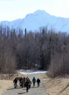 A group of people heads down the Crevasse Moraine trails on Thursday, March 10. Trails users and local residents are concerned about proposed expansion of the nearby landfill, which they say 