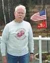 The U.S. flag and the flag of the U.S. Marine Corps still fly
proudly outside of Jim Grazzell's Wasilla home. Photo by CASEY
RESSLER/Frontiersman.