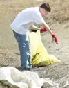 ROBERT DeBERRY/Frontiersman Matthew Nekeferoff, 13, empties the
contents a discarded bottle in the drainage ditch near the Wasilla
Fred Meyer along the Parks Highway Monday afternoon. Nekefer