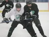 A pair of Colony High School varsity hockey players battle for a puck during practice Thursday afternoon at the Curtis C. Menard II Memorial Ice Arena in Wasilla. Colony faces the Wasilla War