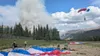 Smokejumpers pack up their gear while another descends while responding to the Riley Fire (#318) near the Denali National Park entrance Sunday afternoon.  Bradley Hagstrom/National Park Servi