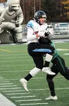 Chugiak's Derryk Snell goes up to catch a pass along the sideline and managed to get a foot down even as he was driven out of bounds by a Colony defender. The 10-yard gain moved the chains on