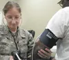 Master Sgt. Jessica Alvarez, a medical technician with the
Alaska Air National Guard’s 176th Medical Group, measures the blood
pressure May 3 of an area resident at a free medical clinic in
H