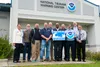 Members from the National Oceanic and Atmospheric Association, the Federal Emergency Management Agency, and other emergency response organizations pose for a photo at the National Tsunami War