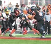 Houston quarterback Nai Saechao pitches to Houston's Billy Etuckmelra during a recent game against the Seward Seahawks at Houston High School. The Hawks play on the road this week against the