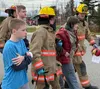Student actors played victims in a real-world scenario of an active shooter. Here, first responders escort students from the school. Katie Stavick/Frontiersman