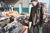 Hicks Creek Auction Co. owner Arnie Hrncir looks over the pallets of equipment going up for auction Saturday at the company’s purpose building location at Mile 1, Palmer-Wasilla Highway. ROBE