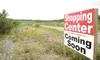 ROBERT deBERRY/Frontiersman A sign advertising a shopping center
in a field along Knik-Goose Bay Road is a symbol of what is to
become of one of the fastest growing areas in the Mat-Su
Boroug