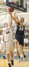 DEREK CLARKSON/Kodiak Daily Mirror Wasilla’s John Knowles
attempts to block the shot of Soldotna’s Daniel Geller during the
boys Northern Lights Conference championship game Saturday evening
