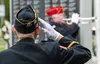 A member of the American Legion 35 Color Guard salutes while Hank Hartman plays 'Taps' at the Memorial Day Celebration at The Veterans Wall of Honor Monday, May 27, 2024. J. David McChesney/F