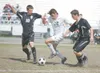 ROBERT DeBERRY/Frontiersman Colony senior Weston Patrick moves
the ball past Nikiski’s Wiley Bennett and Beau Calderwood during
the second half of Thursday’s game at Colony High School.