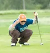 Seth Mascho, 8, checks the position of his golf ball before
putting on the first hole of Monday’s junior golf tournament.
ROBERT DeBERRY/Frontiersman