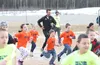 Los Angeles model and ultra runner Ryan Young follows Knik and Goose Bay Elementary School students on a mad dash around the field behind Goose Bay after assemblies at each school on Friday m