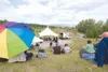 A small crowd sits on the hill at Wonderland Park and listens to
music during Thursday's Rock the Park. (ROBERT
DeBERRY/Frontiersman)