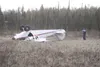 An Alaska State Trooper takes a photograph of a Piper PA-12 bush
plane that lost power around 3:15 p.m. and crashed in a marsh off
Caribou and Charley streets. (K.T. McKEE/Frontiersman)