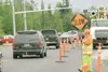 ROBERT DeBERRY/Frontiersman Leslie Wright keeps traffic slow
near the intersection of Wagon Road and the Palmer-Wasilla Highway
Thursday afternoon where workers were installing traffic signal