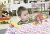 Aarnout Horton, 3, plays with a car he built out of blocks while
Kelly Harned, 4, works his own project in the background. The two
boys played at the Meadow Lakes Early Learning Center Aug. 9