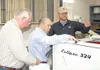 Courtesy photo USDA Natural Resources Conservation Service Chief
Arlen Lancaster (center) looks at some of the seeds being processed
at the Alaska Plant Materials Center in the Butte. Seeds a