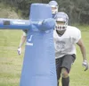 JEREMIAH BARTZ/Frontiersman Palmer sophomore James Nisbett hits
the tackling dummy during a team practice on Wednesday.