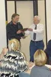 Above, Tom Hood, owner of Mile 49 CafŽ, receives an award from
Lee Himes, board member of the Meadow Lakes Community Council, for
his service to the community. Photo by SCOTT
CHRISTIANSEN/Fro