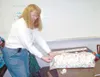Courtesy photo A volunteer for the Santa Cop program wraps gifts
for Valley seniors.