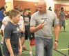 Seattle Seahawks defensive line coach Todd Wash works with a young participant during the Play 60 Challenge event at the AT&amp;T Sports Center on Friday. JEREMIAH BARTZ/Frontiersman