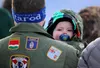 Cruze Tanner, 2, peers of the shoulder of father Jesse Tanner during the Veterans Memorial at the Wall of Honor Wednesday morning. A freezing cold could not keep veterans from turning out for
