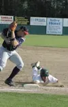 Mat-Su Miners catcher Mathew Inouye slides into first and avoids
the tag by AIA's Eric Streelman during the Miners' 2-0 victory on
Wednesday. Photo JEREMIAH BARTZ/ Frontiersman.