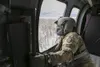 Alaska Army Guard Staff Sgt. Damion Minchaca, an Army critical care flight paramedic with Detachment 2, Golf Company, 2nd General Support Aviation Battalion, 104th Regiment, scans the horizon