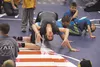 Marcie Van Dusen, 2008 Olympic wrestler, demonstrates an exercise for young wrestlers during a clinic at the Curtis D. Menard Memorial Sports Center prior to the start of the Alaska USA Wrest