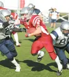 Robert DeBerry/Frontiersman Wasilla’s Joe Barkley fends off
Eagle River tacklers on his way to a gain Friday in Anchorage.
Despite playing his first football game since the seventh grade,
Bar