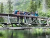 Advisers Kelly Parsons and Sharon Diefenderfer stand with Venture Crew 300 members Rebekah Johanson, Courtney DeFillipo, Taia Fagerstrom and Carmen Soto on a bridge over Crescent Creek, which